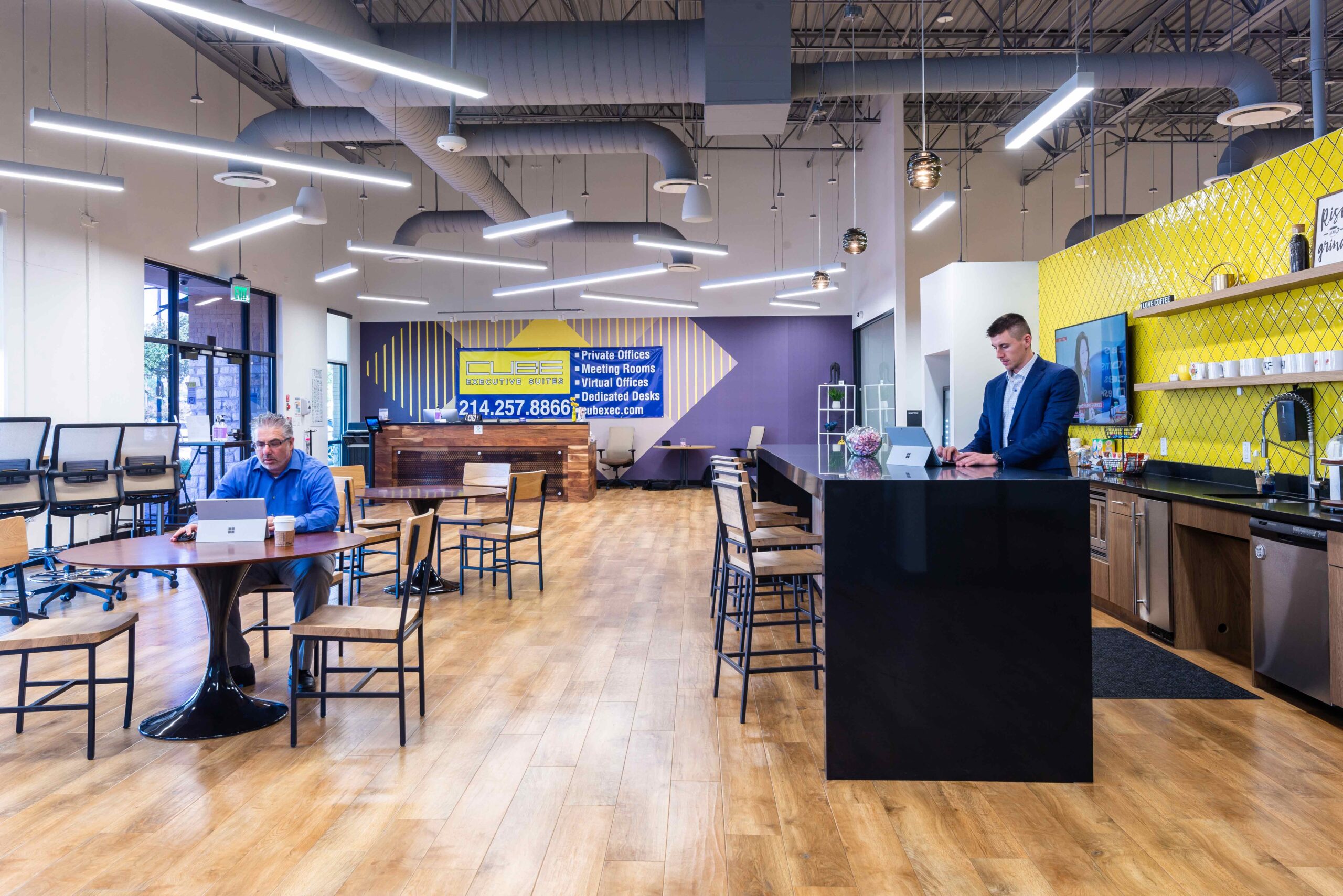 Coworking space in Dallas. Main room has many tables for groups of 4 to meet in a shared office space.