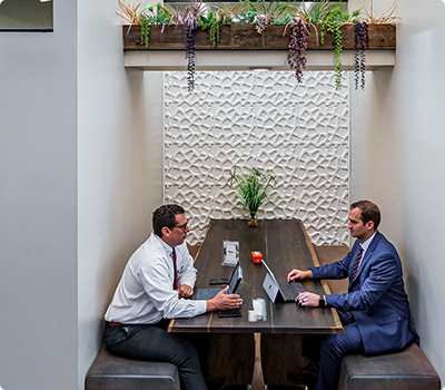 Coworking space in Phoenix. Meeting space in a booth allows for chat transition to lunch.