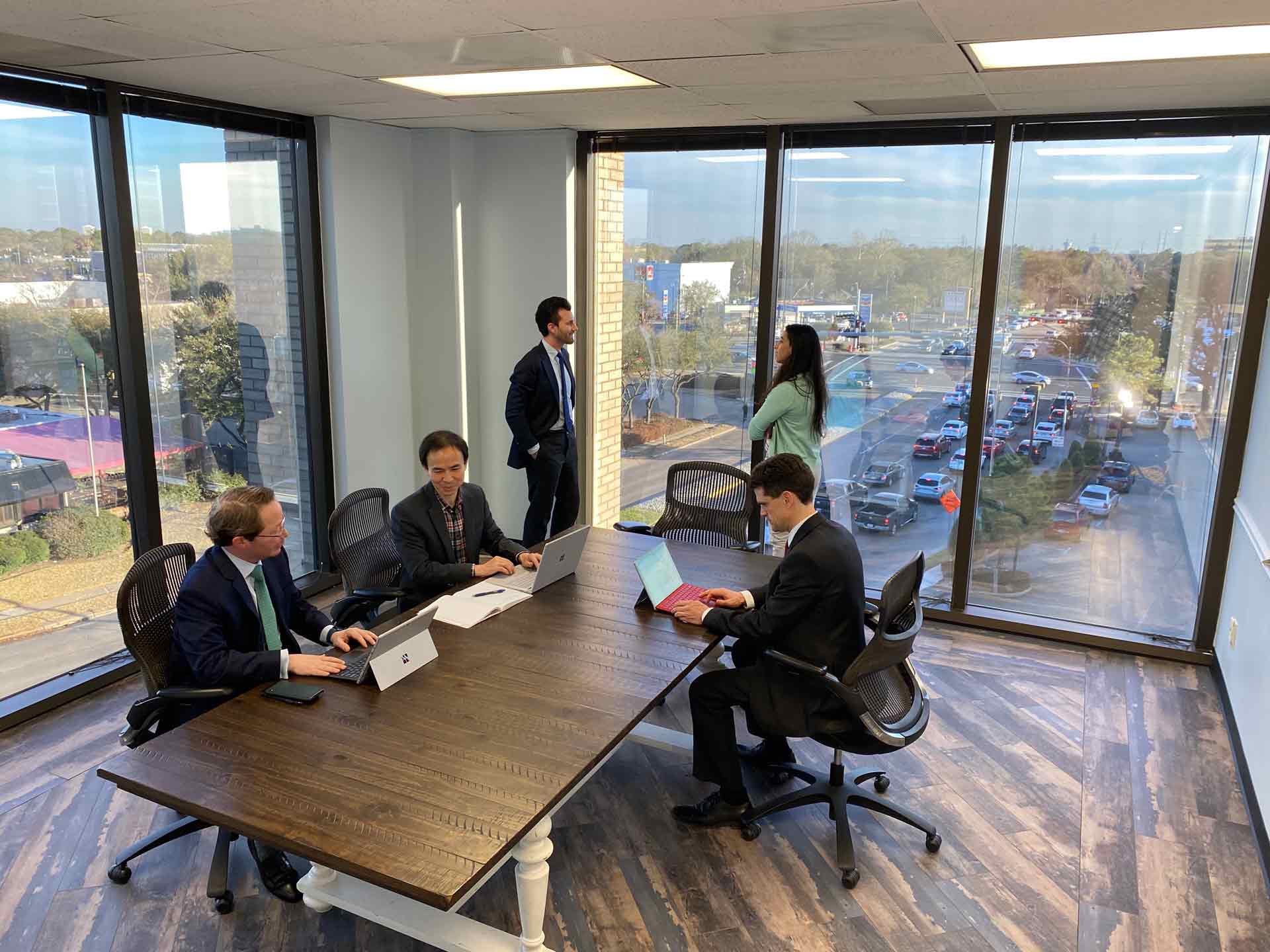 Houston meeting space with floor to ceiling windows. Conference room has table and chairs for 4.