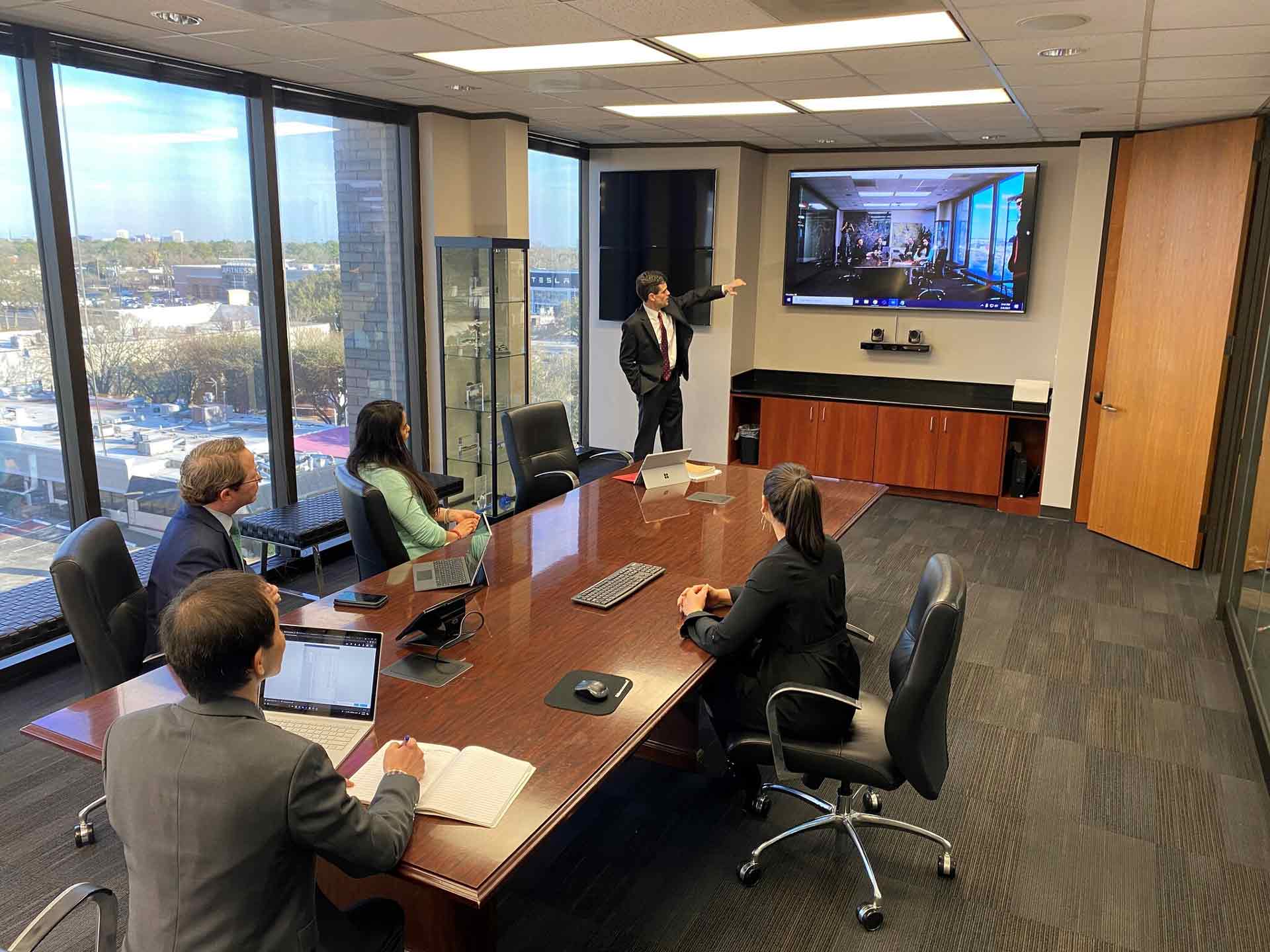 Conference room rental in Houston. Boardroom has TV, large table and seating for 6.