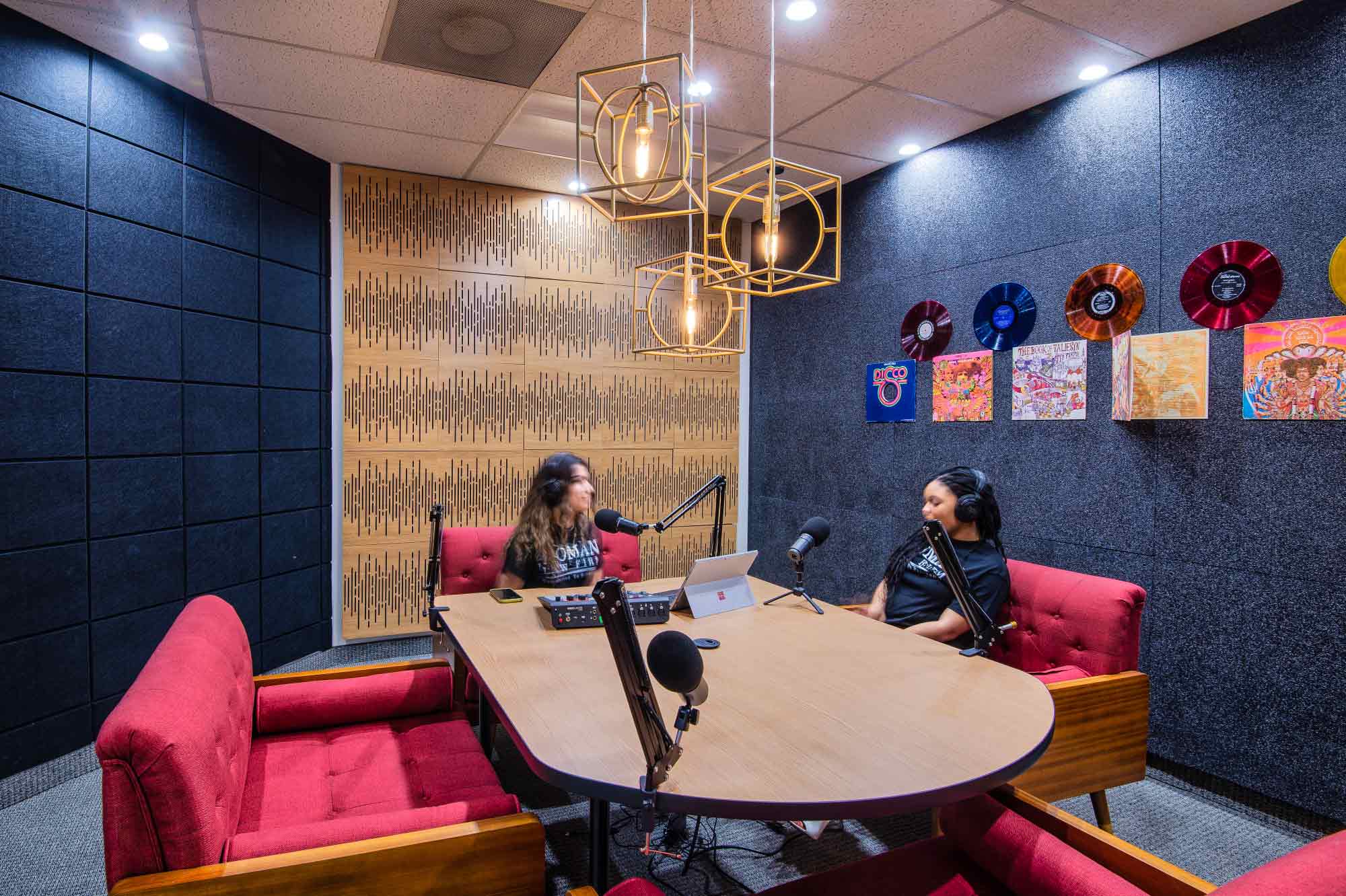 Podcast Room in CUBExec at Uptown Dallas. It has 4 red chairs and 4 mics.