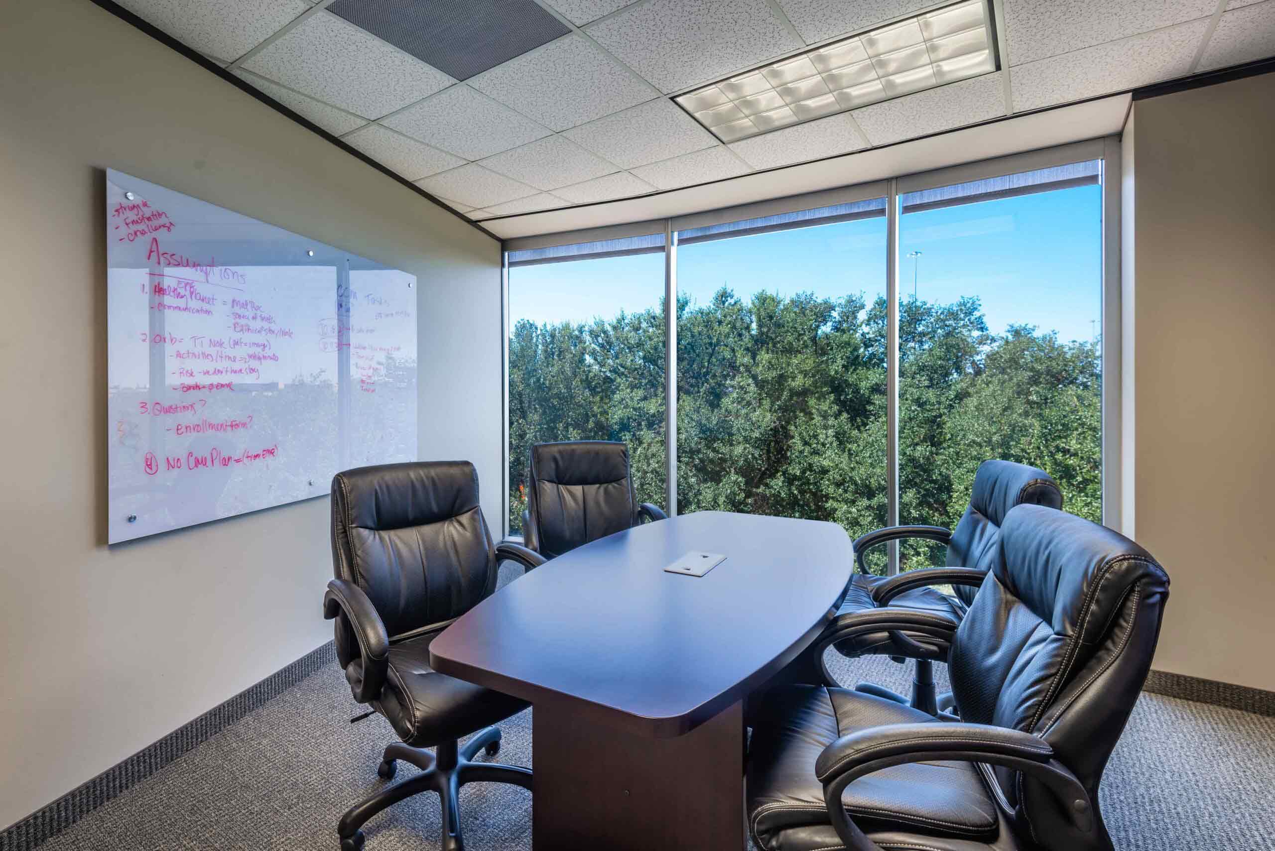 North Dallas meeting space with room to sit 4 people. Large floor to ceiling windows let in natural light.